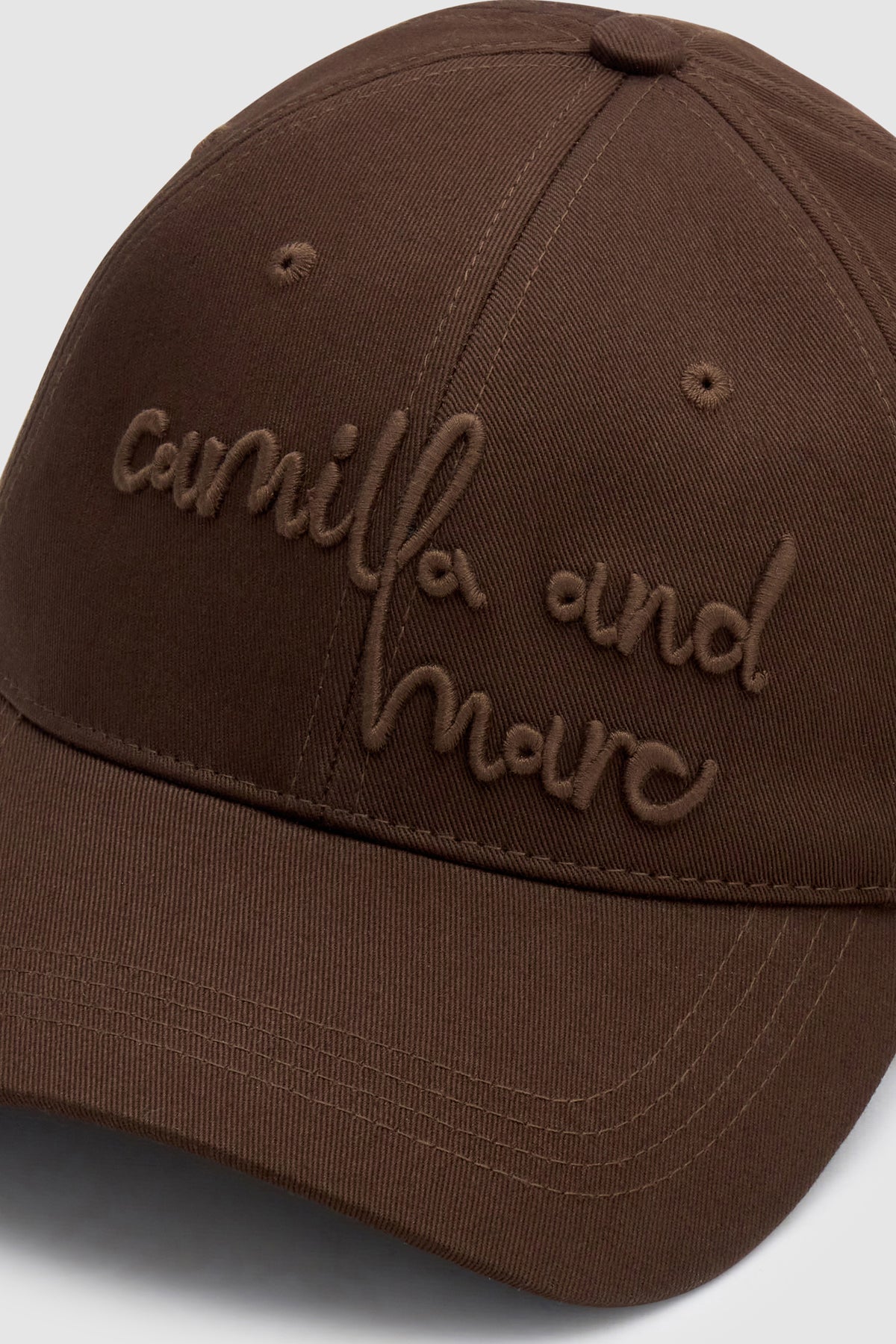 Cropped view CAMILLA AND MARC Maren Embroidered Cap in Chocolate Brown with front embroidered artwork.