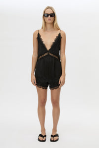 Front styled view CAMILLA AND MARC Mirage Lace Trim Top in Black with V‑neck cami silhouette, and lace border trim.