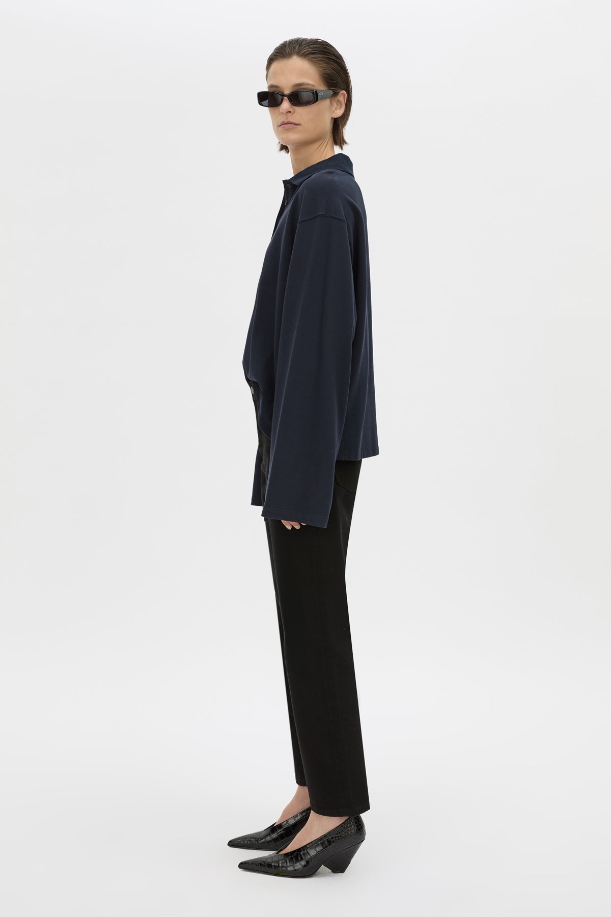 Side view CAMILLA AND MARC cotton Moreno Long Sleeve Polo Top in navy with quarter external button placket.