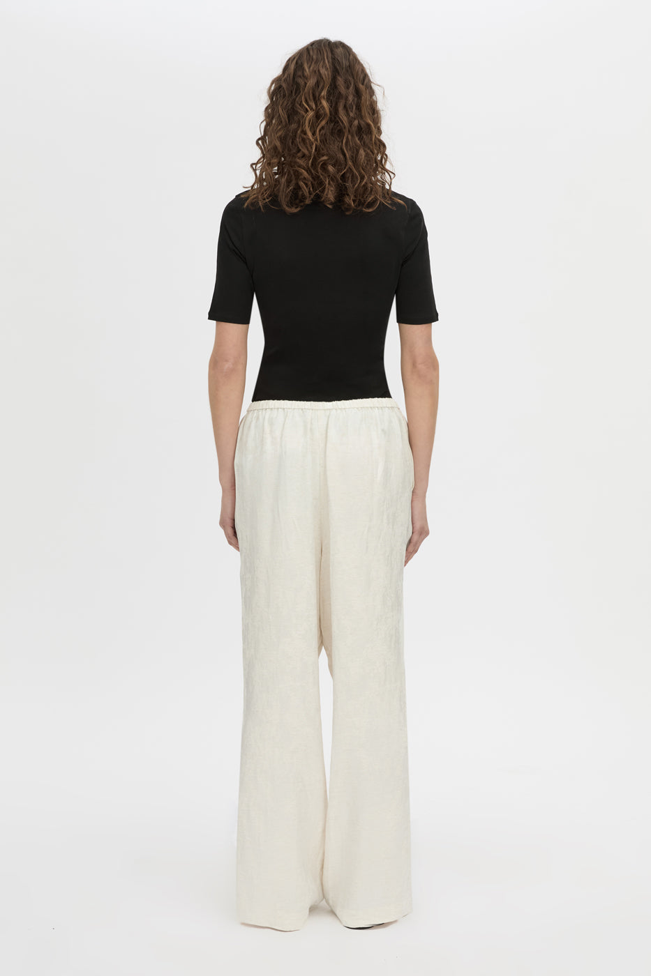 Back view CAMILLA AND MARC mid-rise Naidee Satin Relaxed Pant in ivory white with an elasticated gathered waistband.