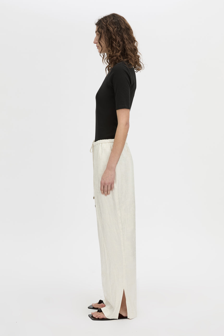 Side view CAMILLA AND MARC mid-rise Naidee Satin Relaxed Pant in ivory white with an elasticated gathered waistband.