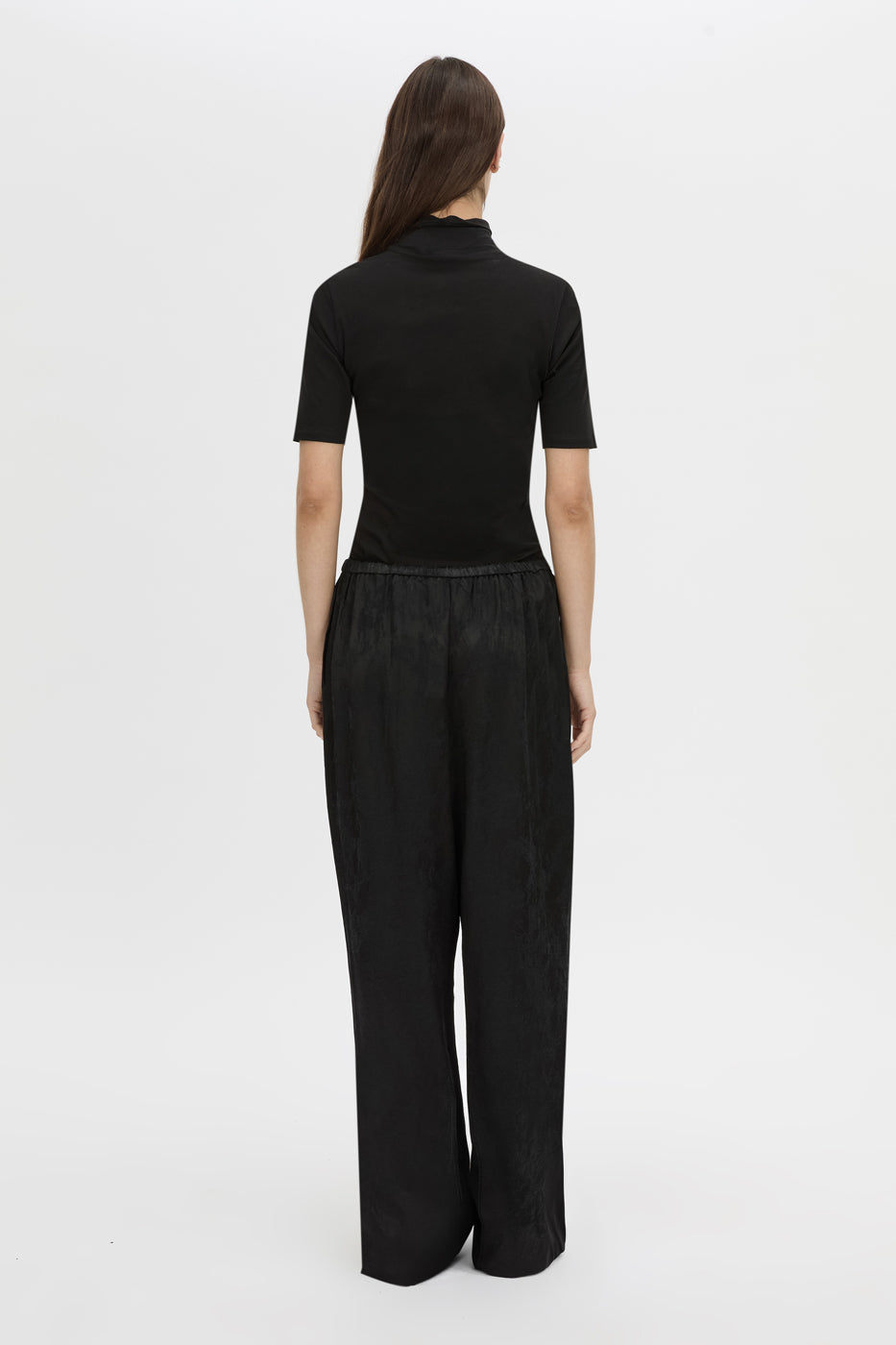 Back view CAMILLA AND MARC mid-rise Naidee Satin Relaxed Pant in black with an elasticated gathered waistband.