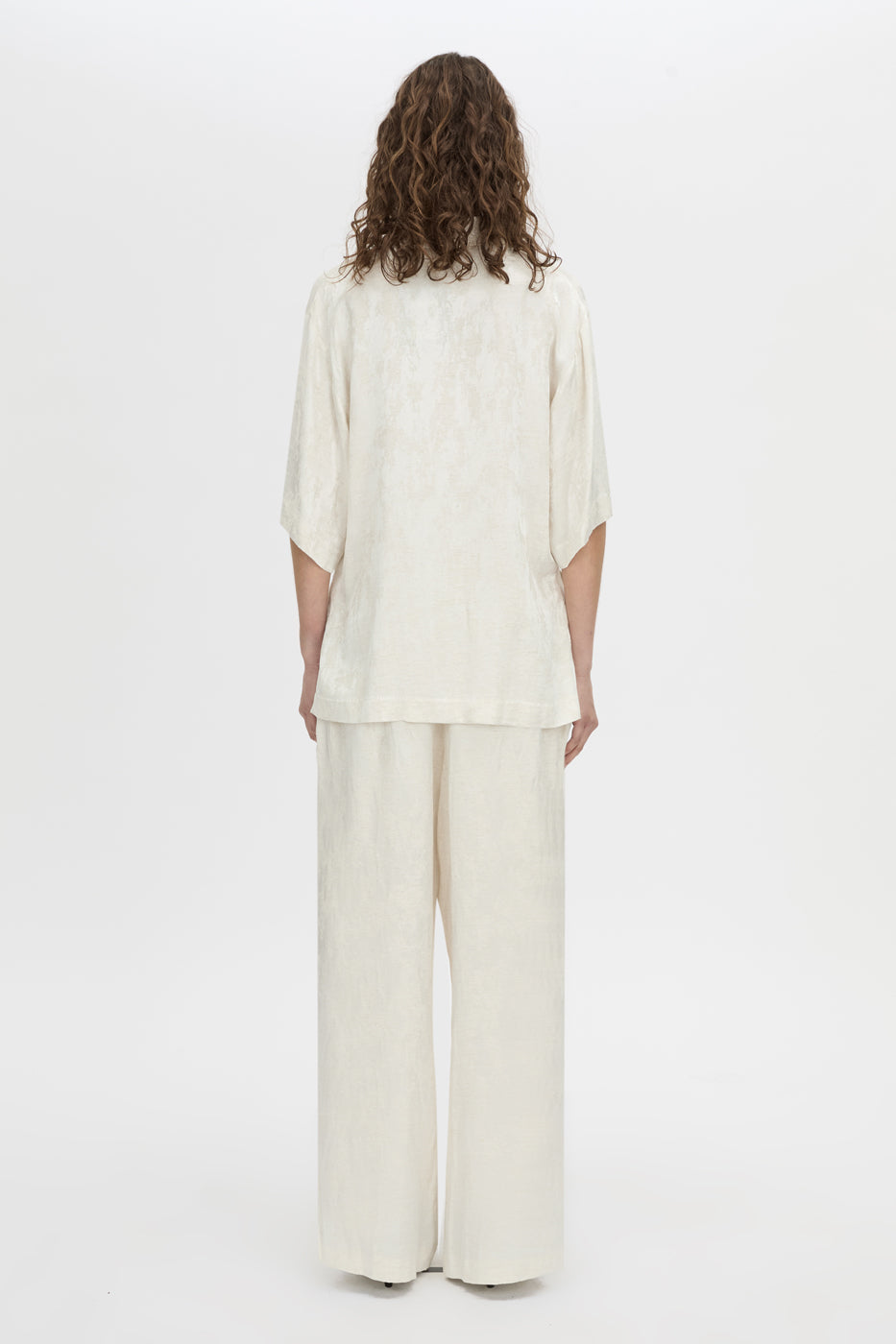 Back view CAMILLA AND MARC Naidee Satin Short Sleeve Shirt in ivory white.