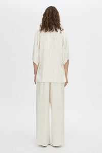 Back view CAMILLA AND MARC Naidee Satin Short Sleeve Shirt in ivory white.