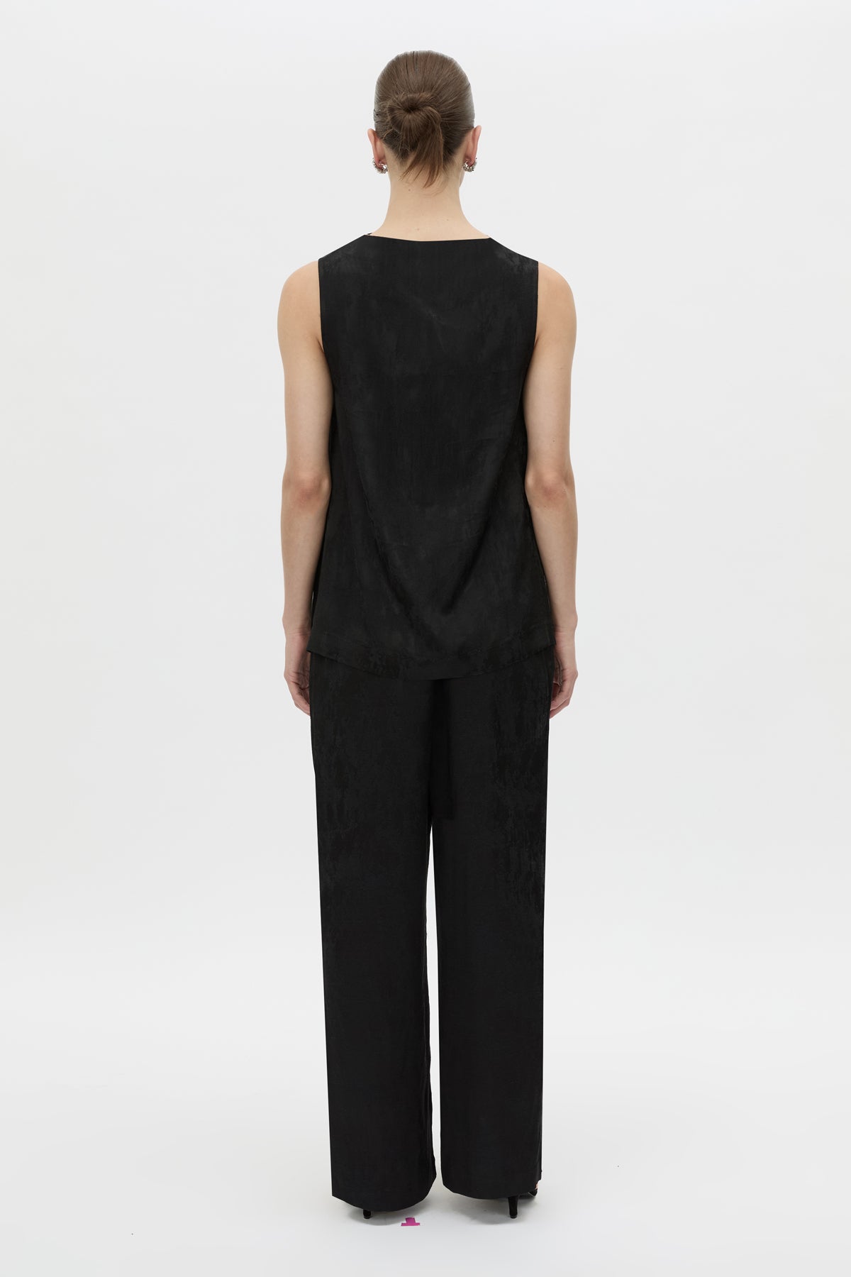 Back view CAMILLA AND MARC Naidee Satin Sleeveless Top in black with sleeveless shell design in satin fabrication.