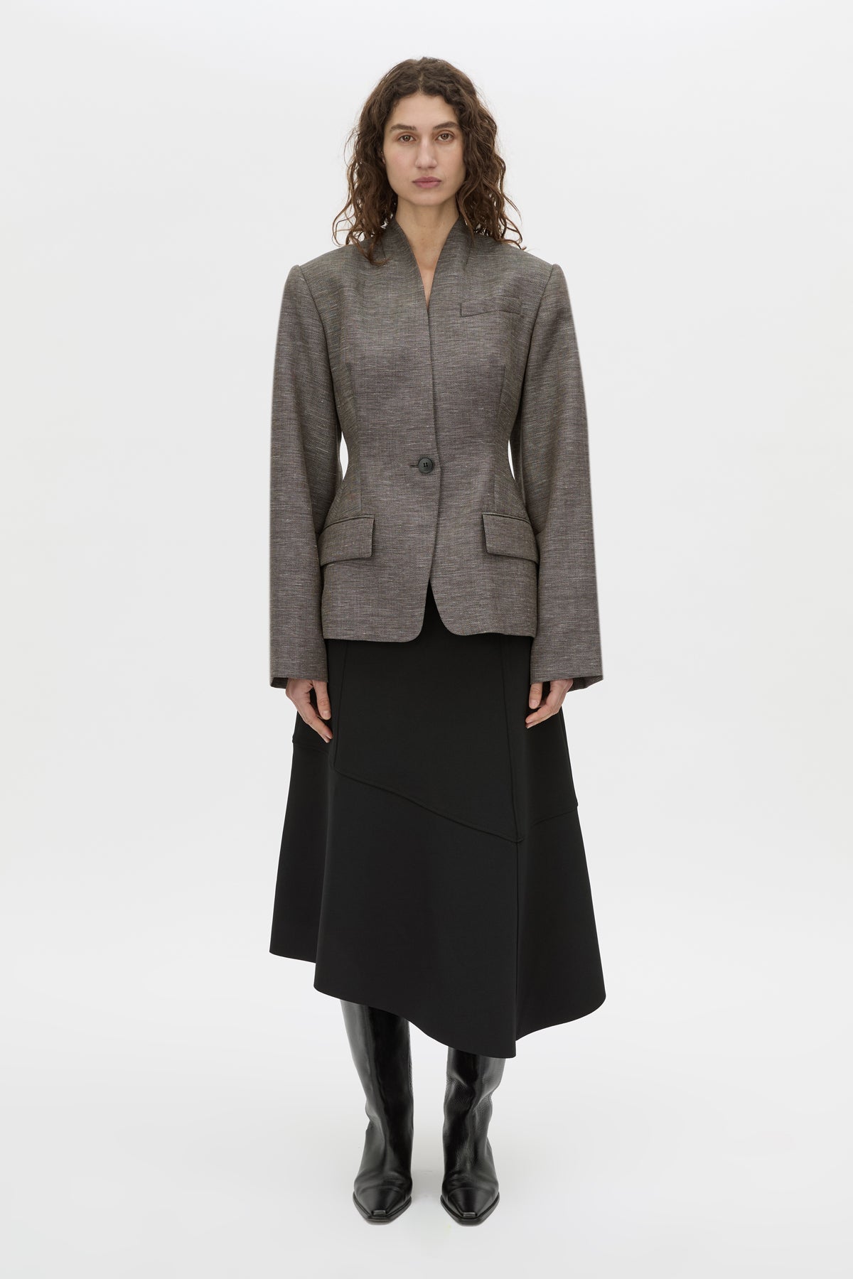 Front-styled-2 view CAMILLA AND MARC high-waisted Namira Midi Skirt in black with asymmetric hemline.