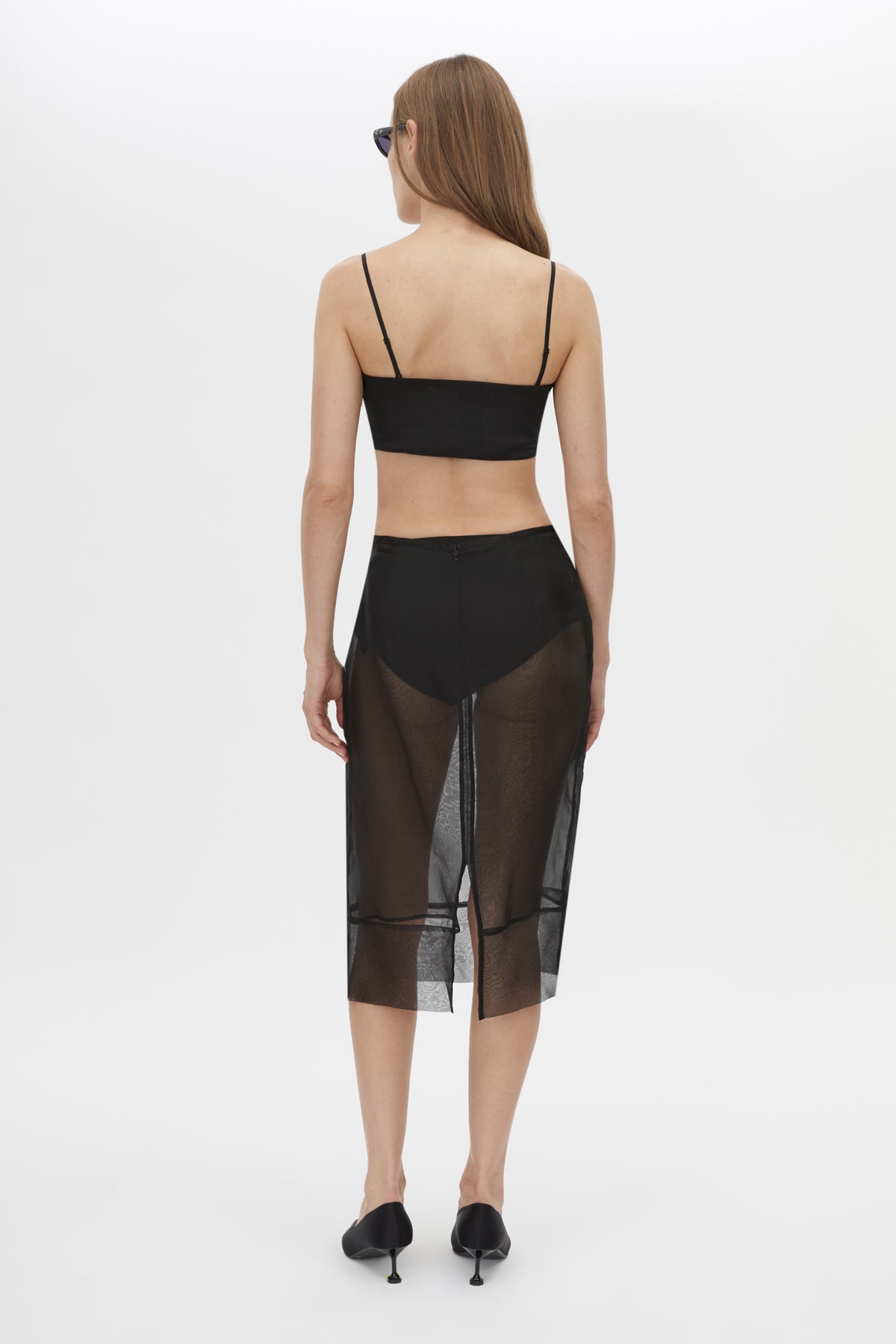 Back view CAMILLA AND MARC Noe Skirt in Black with a sheer high‑waisted pencil midi silhouette.