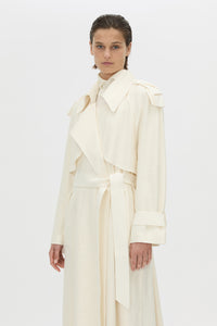 Cropped view CAMILLA AND MARC Ontario Trench Coat in cream with contrast knot epaulette detailing.