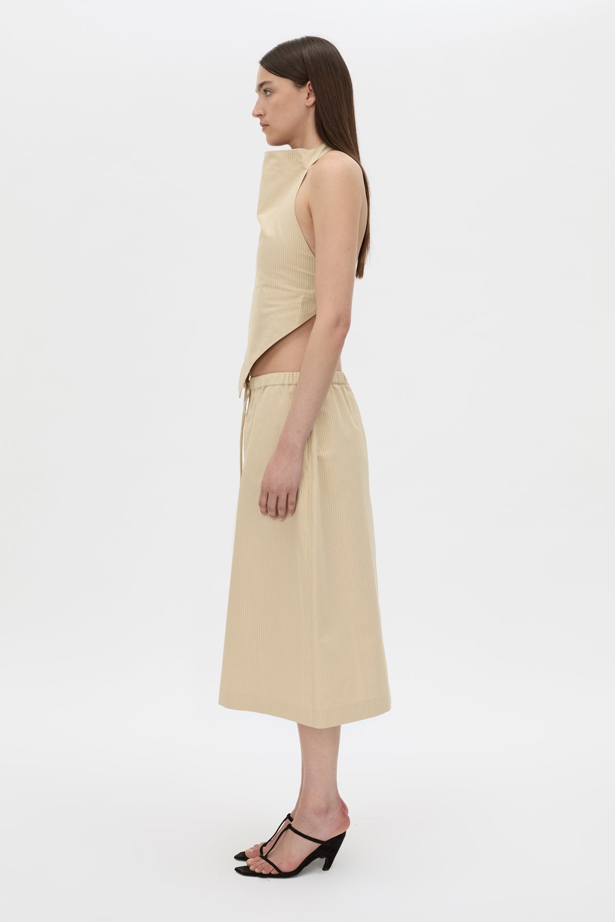 Side view CAMILLA AND MARC Oren Stripe Midi Skirt in ochre stripe with an adjustable mid‑rise waistline.