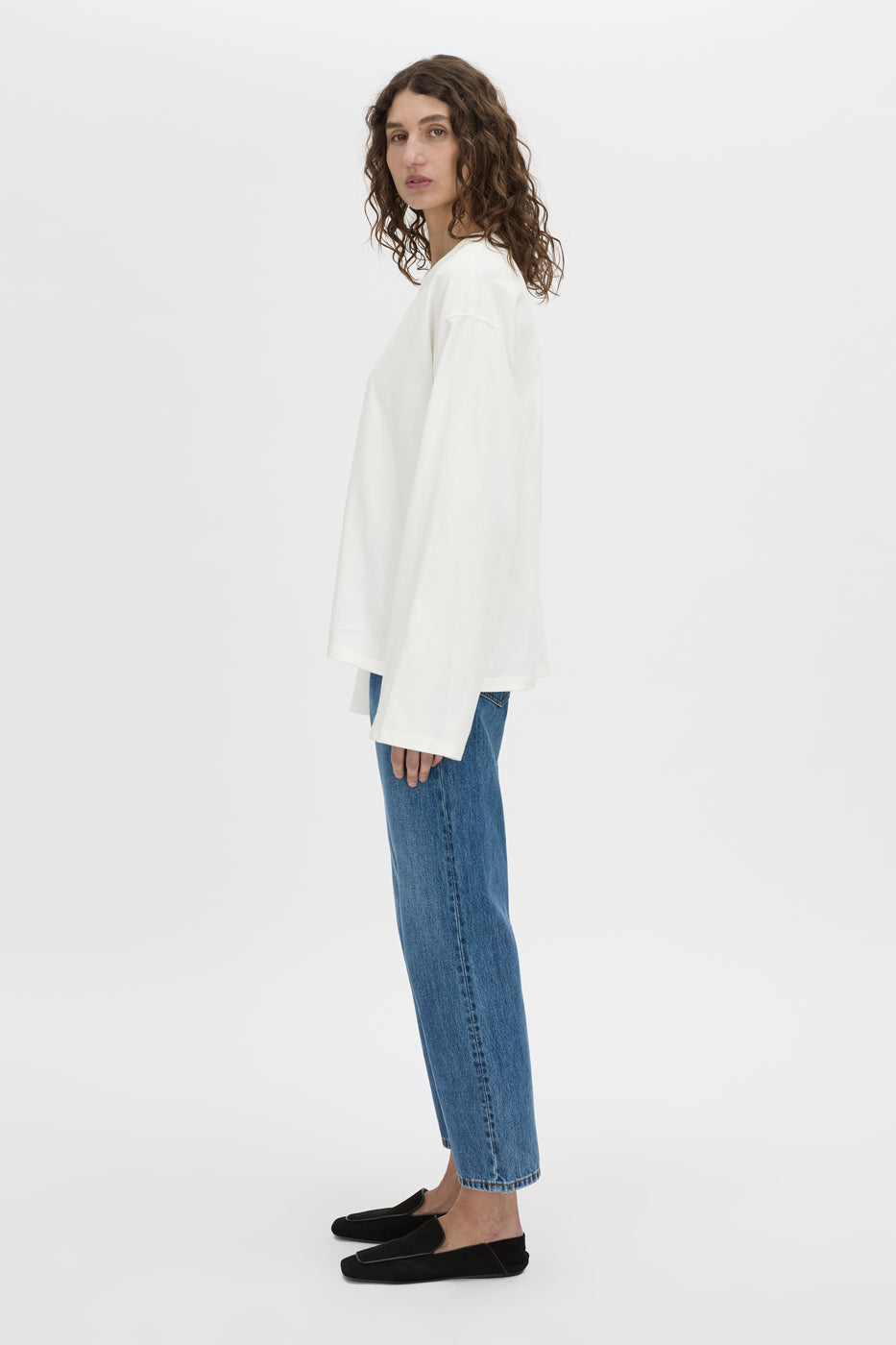 Side view CAMILLA AND MARC Peretti long sleeve tee in white with wide shaped sleeves.