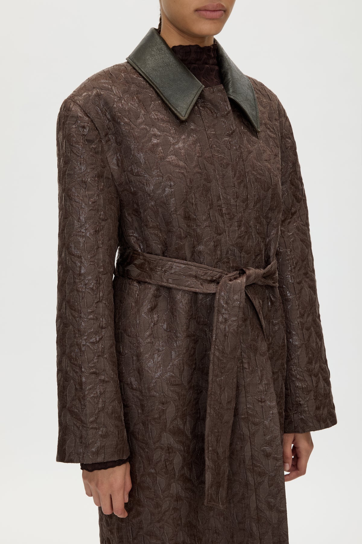 3/4 view CAMILLA AND MARC full-length Rennick Oversized Coat in chocolate brown with contrast leather collar and buckle belt. 