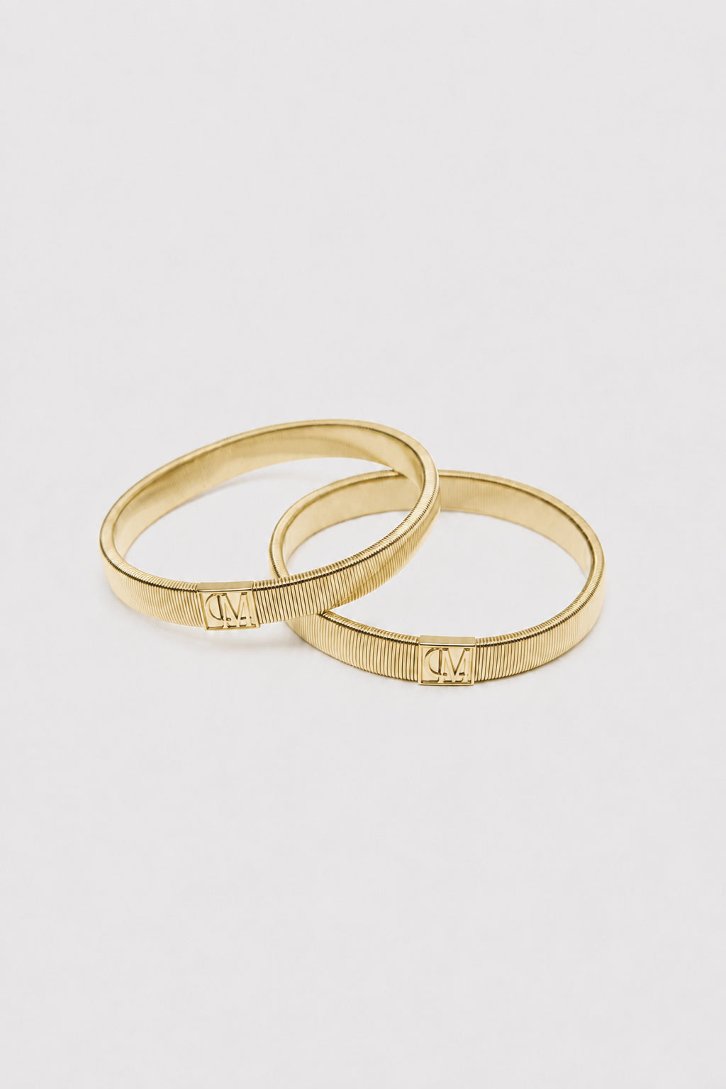 Ghost View - CAMILLA AND MARC Sleeve Monogram garter pair in gold. Worn on the arm to perfectly bunch up any sleeve.