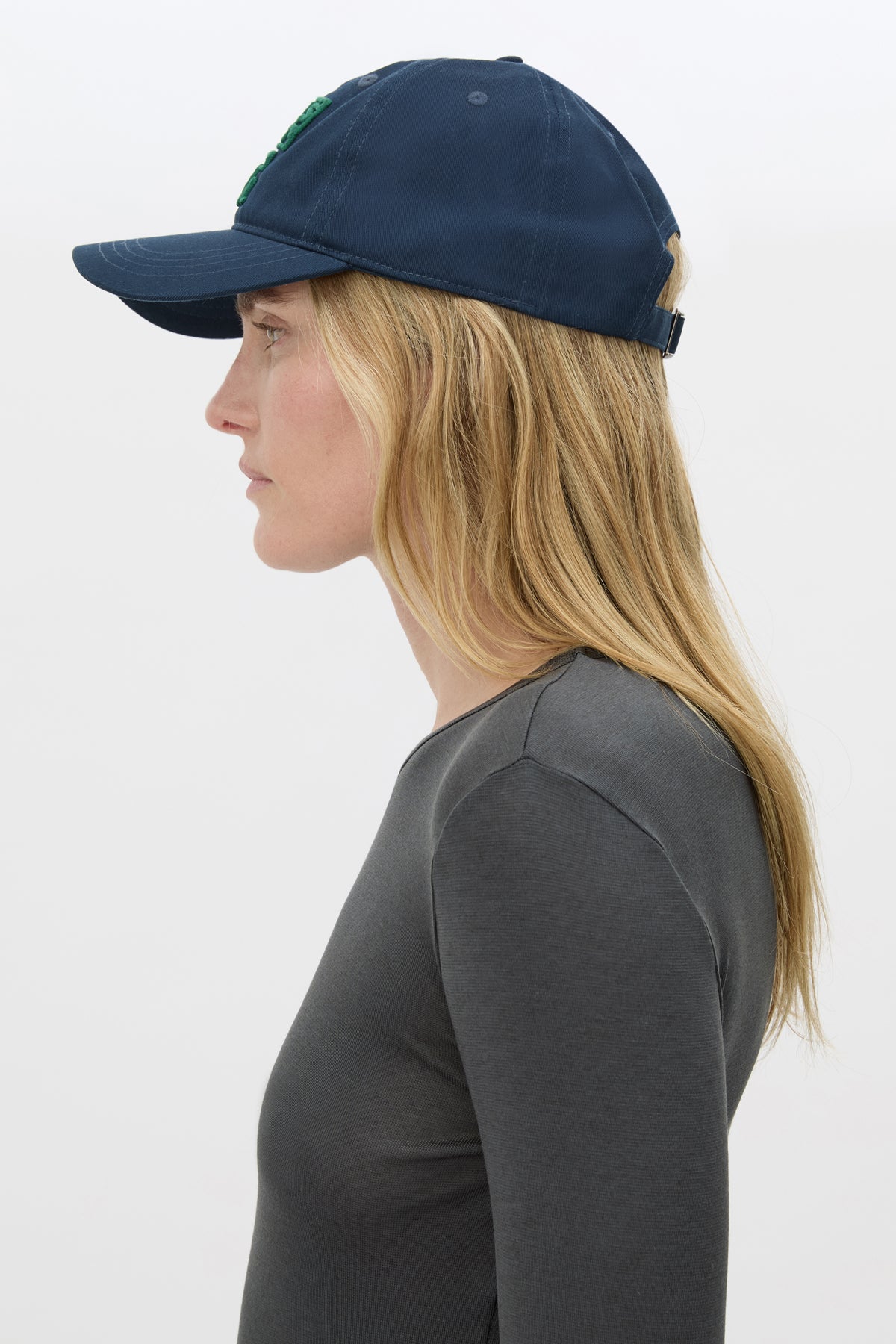 Side view CAMILLA AND MARC Sonora Embroidered Logo Cap in Deep Ink with embroidered artwork.