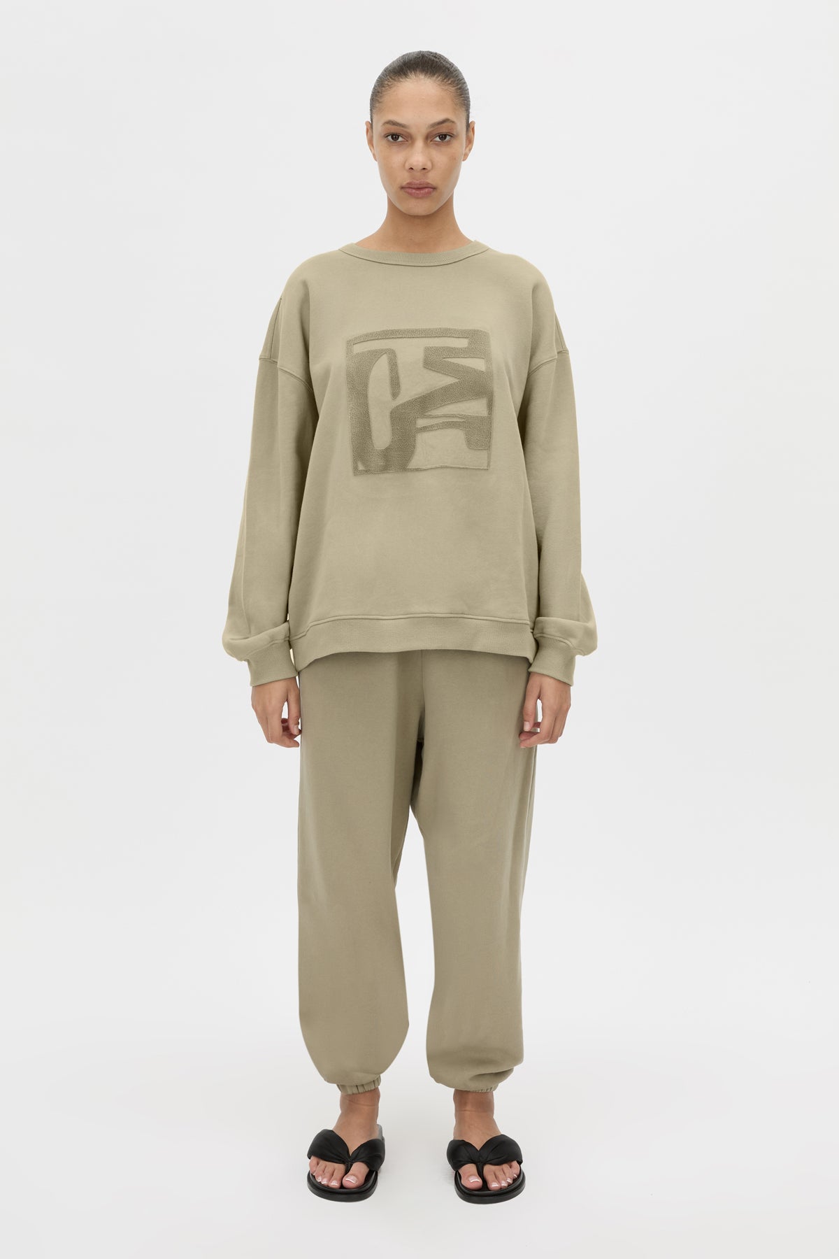 Front view CAMILLA AND MARC Sonora Tracksuit Top in clay with front flocked artwork.