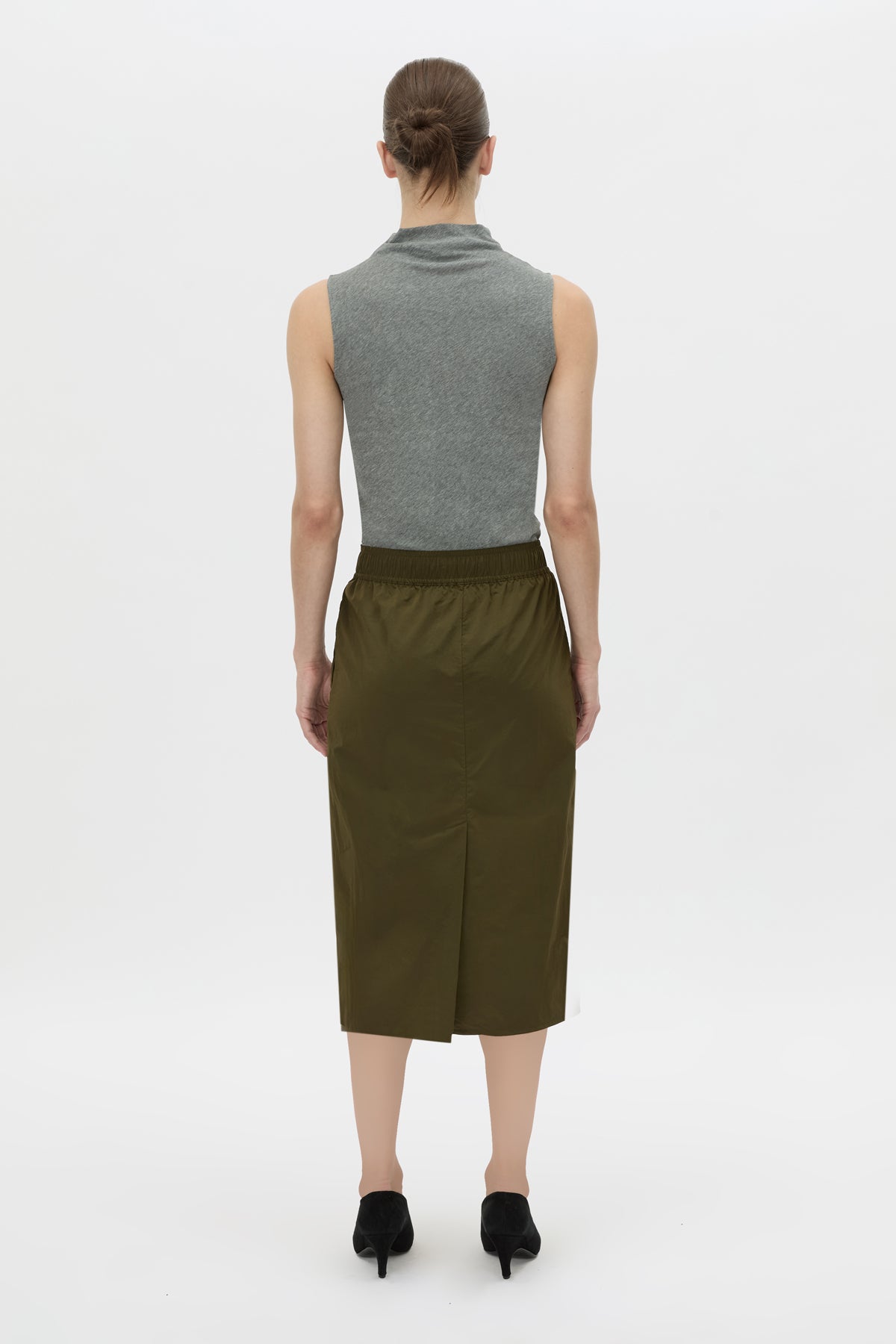 Back view CAMILLA AND MARC Storm Midi Skirt in khaki with an elasticated waistband, slanted side pockets and a back vent.