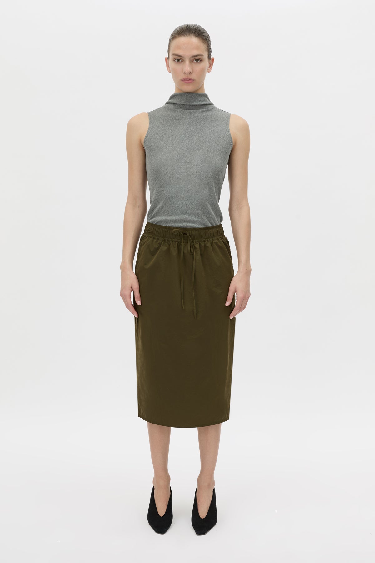 Front view CAMILLA AND MARC Storm Midi Skirt in khaki with an elasticated waistband, slanted side pockets and a back vent.