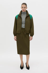 Styled view CAMILLA AND MARC Storm Midi Skirt in khaki with an elasticated waistband, slanted side pockets and a back vent.