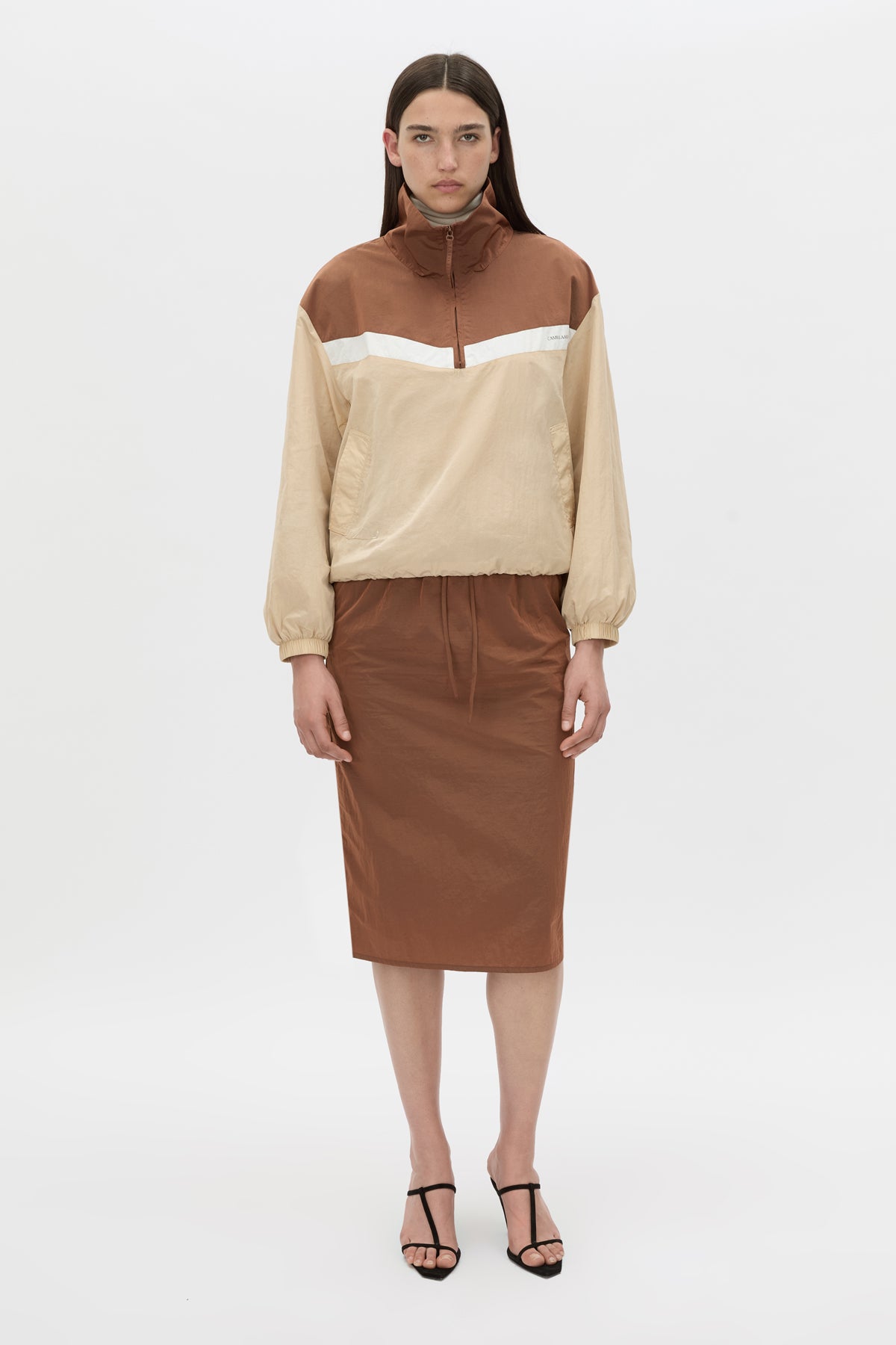 Front-styled view CAMILLA AND MARC Storm Midi Skirt in mocha with an elasticated waistband, slanted side pockets and a back vent.