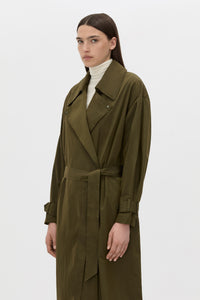 Cropped view CAMILLA AND MARC Storm Trench Coat in khaki with concealed snap fastenings, in seam pockets and a self tie belt with sleeve straps.