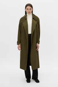 Front-styled view CAMILLA AND MARC Storm Trench Coat in khaki with concealed snap fastenings, in seam pockets and a self tie belt with sleeve straps.