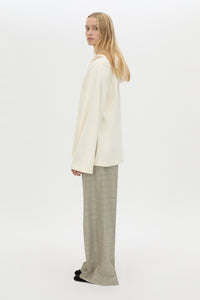 Side view CAMILLA AND MARC Studio Hoodie in White with relaxed long‑sleeve design and hooded silhouette.  