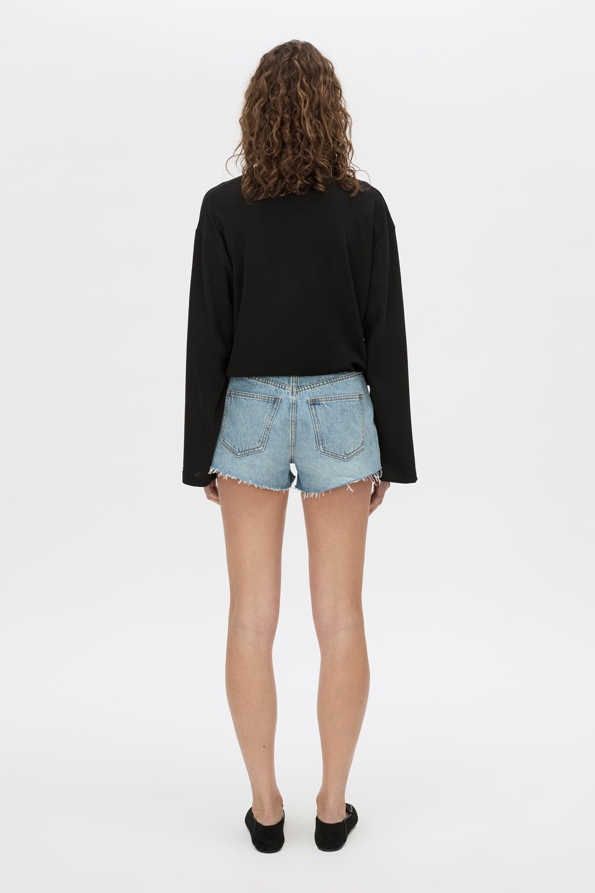 Back view CAMILLA AND MARC Tanner Denim Mini Short in light blue with raw‑hem.
