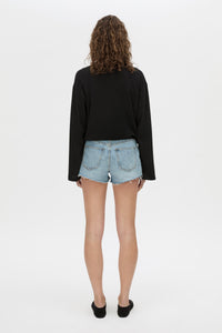 Back view CAMILLA AND MARC Tanner Denim Mini Short in light blue with raw‑hem.