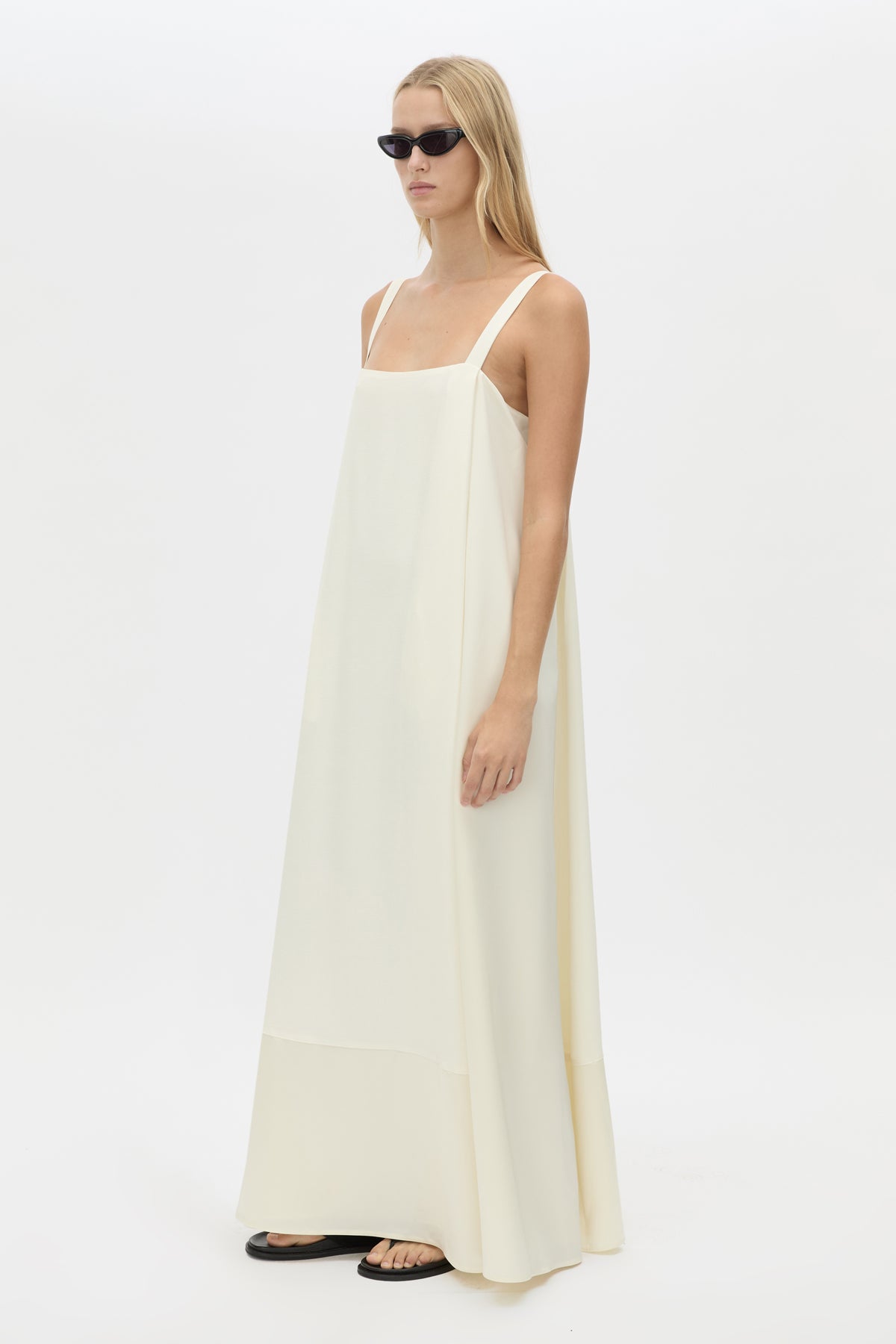 Three-quarter view CAMILLA AND MARC Tove Maxi Dress in Cream with a sleeveless silhouette and contrasting satin trim. 