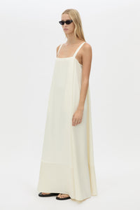 Three-quarter view CAMILLA AND MARC Tove Maxi Dress in Cream with a sleeveless silhouette and contrasting satin trim. 