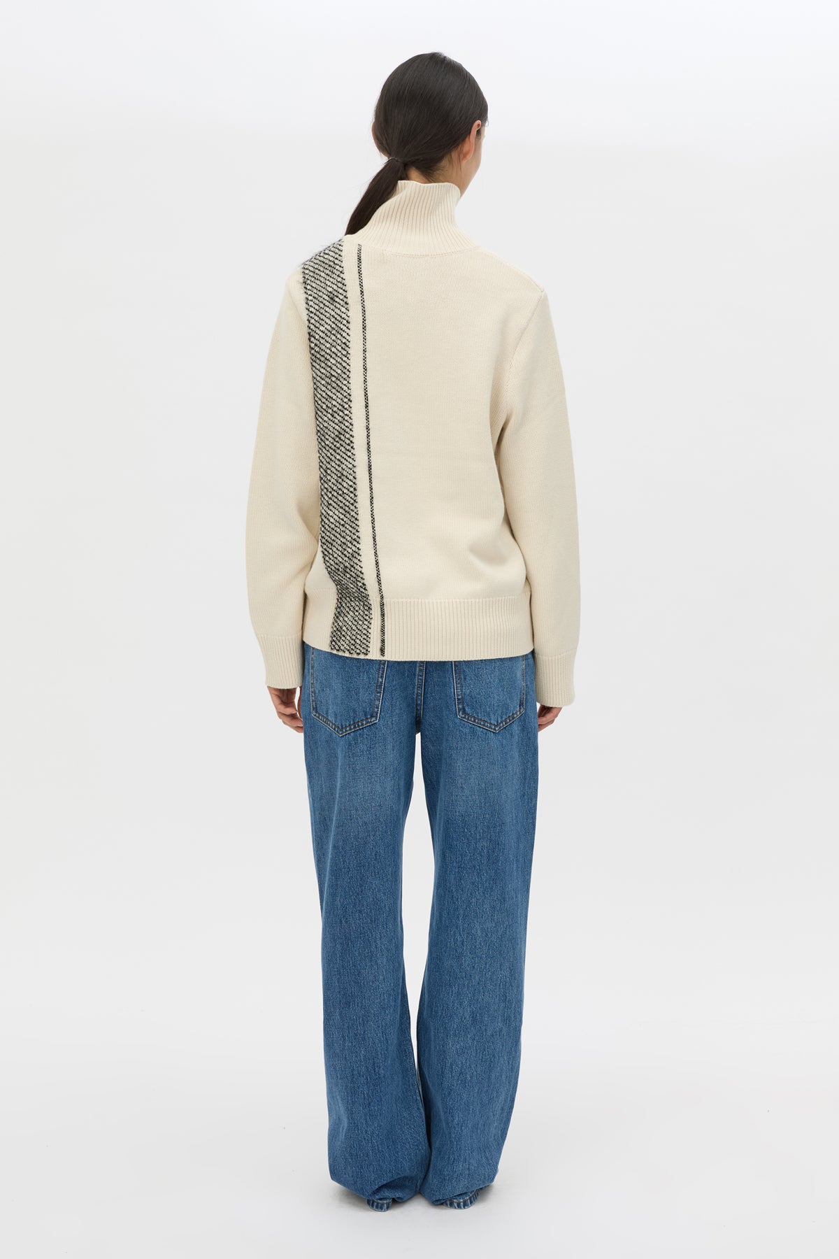 Back view CAMILLA AND MARC Tusk Detail Knit Turtleneck in Black with contrast jacquard stripe and Australian wool.