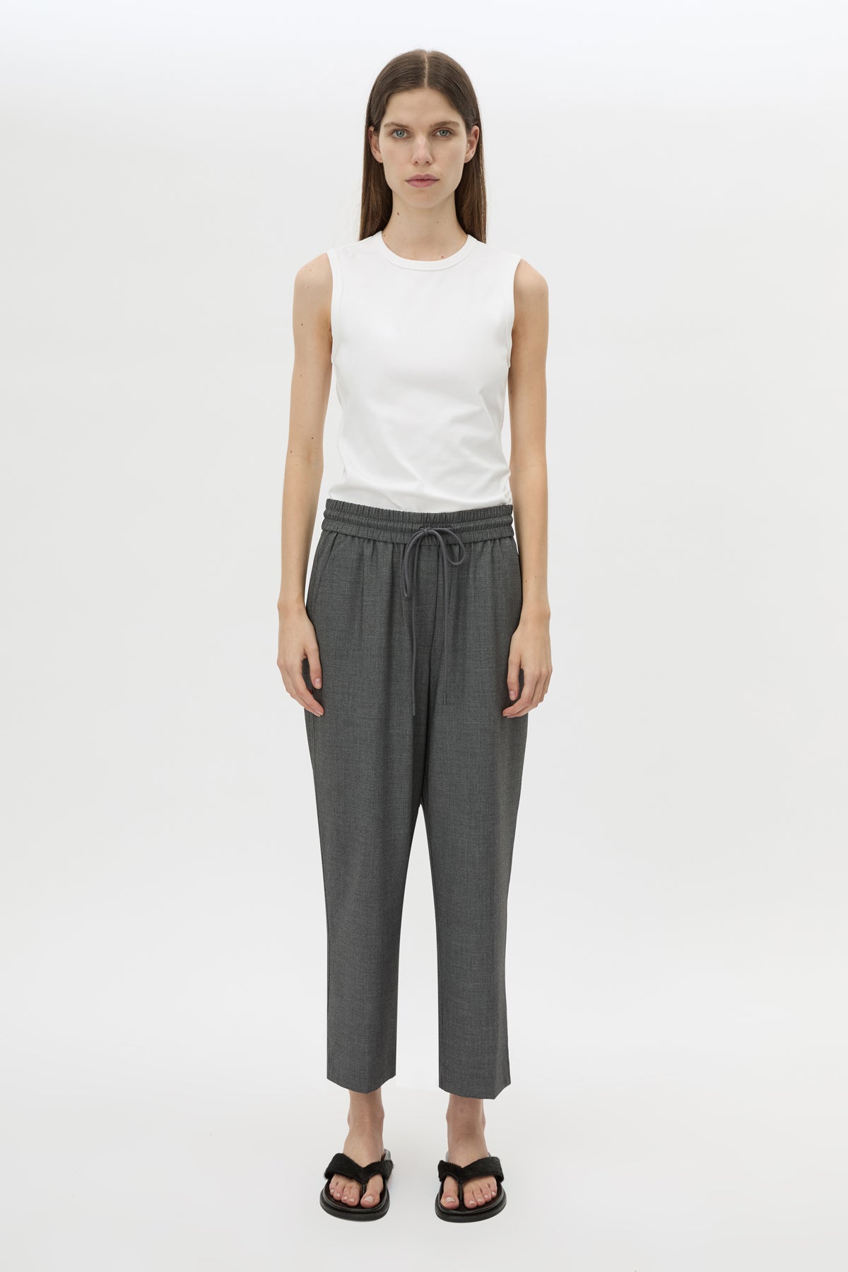 Front styled view CAMILLA AND MARC Vector Crop Pant in Charcoal Grey with soft suiting fabrication.