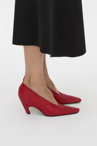 Side styled view CAMILLA AND MARC Wave Textured Pump in red laser‑cut goat leather.