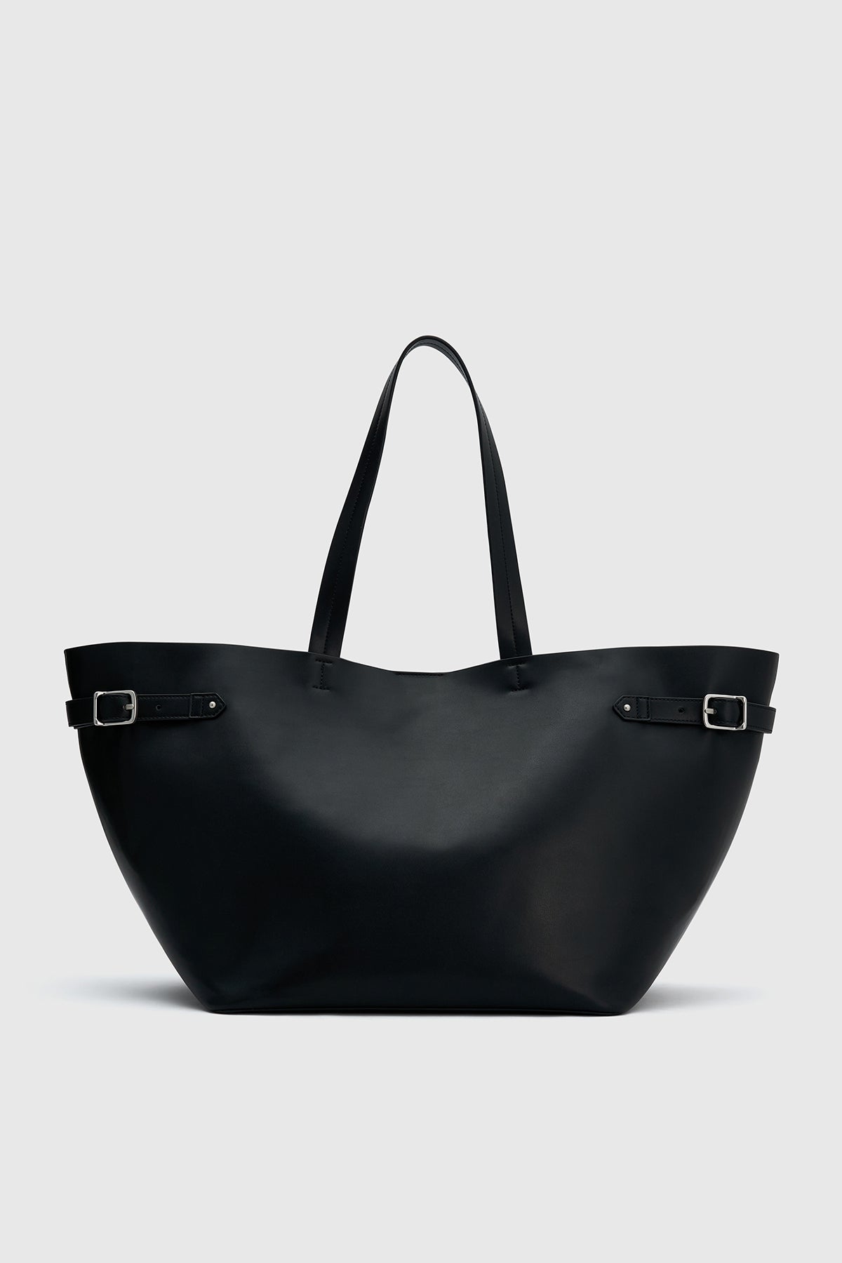Ghost view CAMILLA AND MARC Willa Tote in Black with side strap and buckle detailing and magnetic button closure.