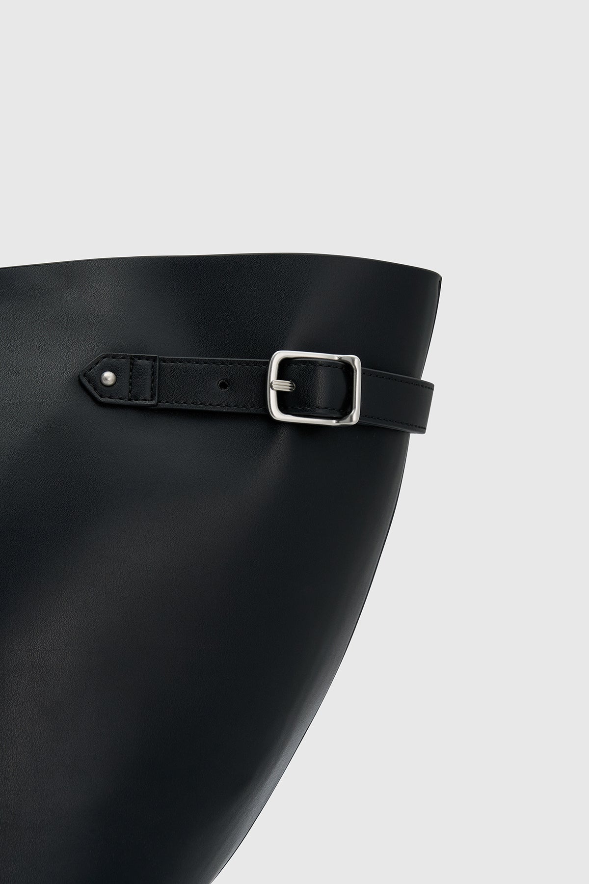 Cropped view CAMILLA AND MARC Willa Tote in Black with side strap and buckle detailing and magnetic button closure.