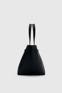 Side view CAMILLA AND MARC Willa Tote in Black with side strap and buckle detailing and magnetic button closure.
