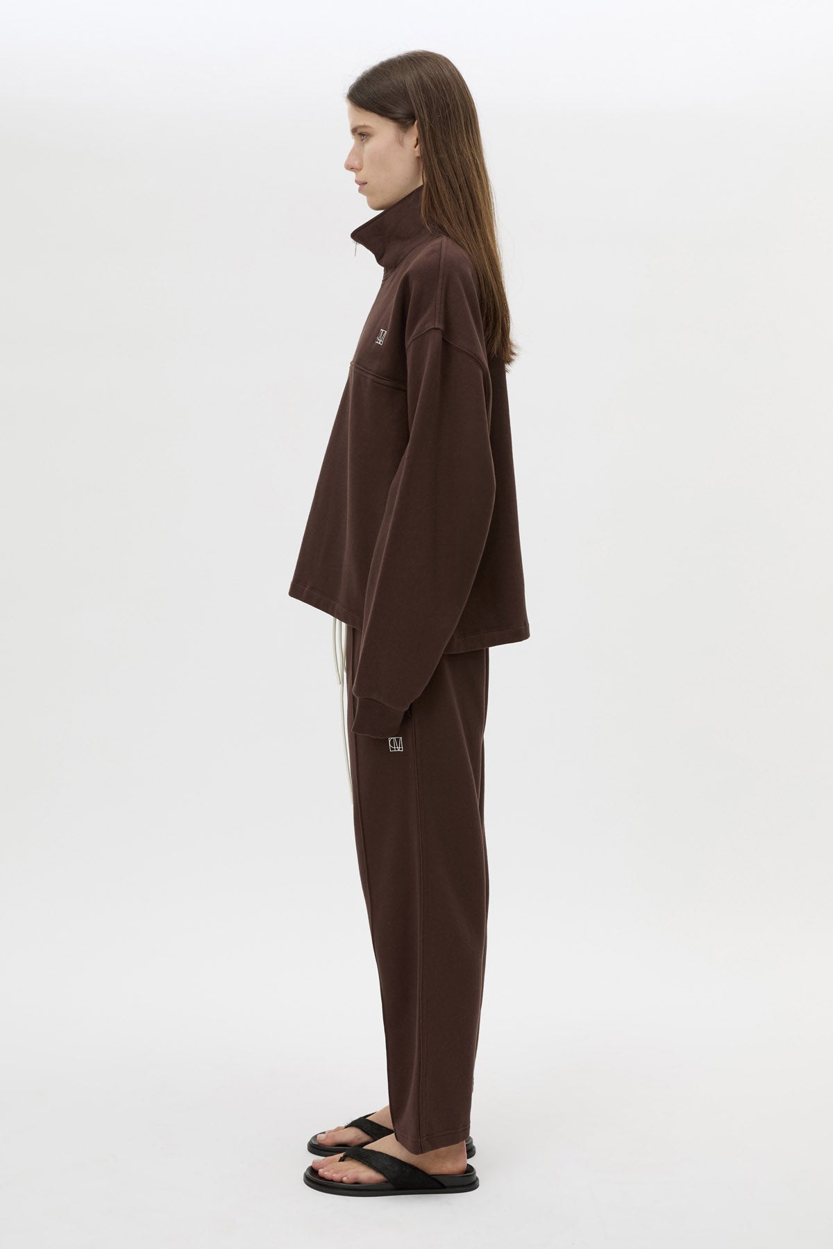 Side view CAMILLA AND MARC Zylus funnel neck pullover sweater in chocolate/white with contrast embroidered monogram.