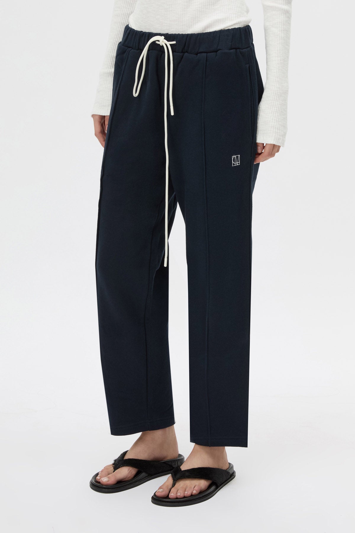 Cropped view CAMILLA AND MARC Zylus straight-leg tracksuit pant in navy with embroidered monogram.