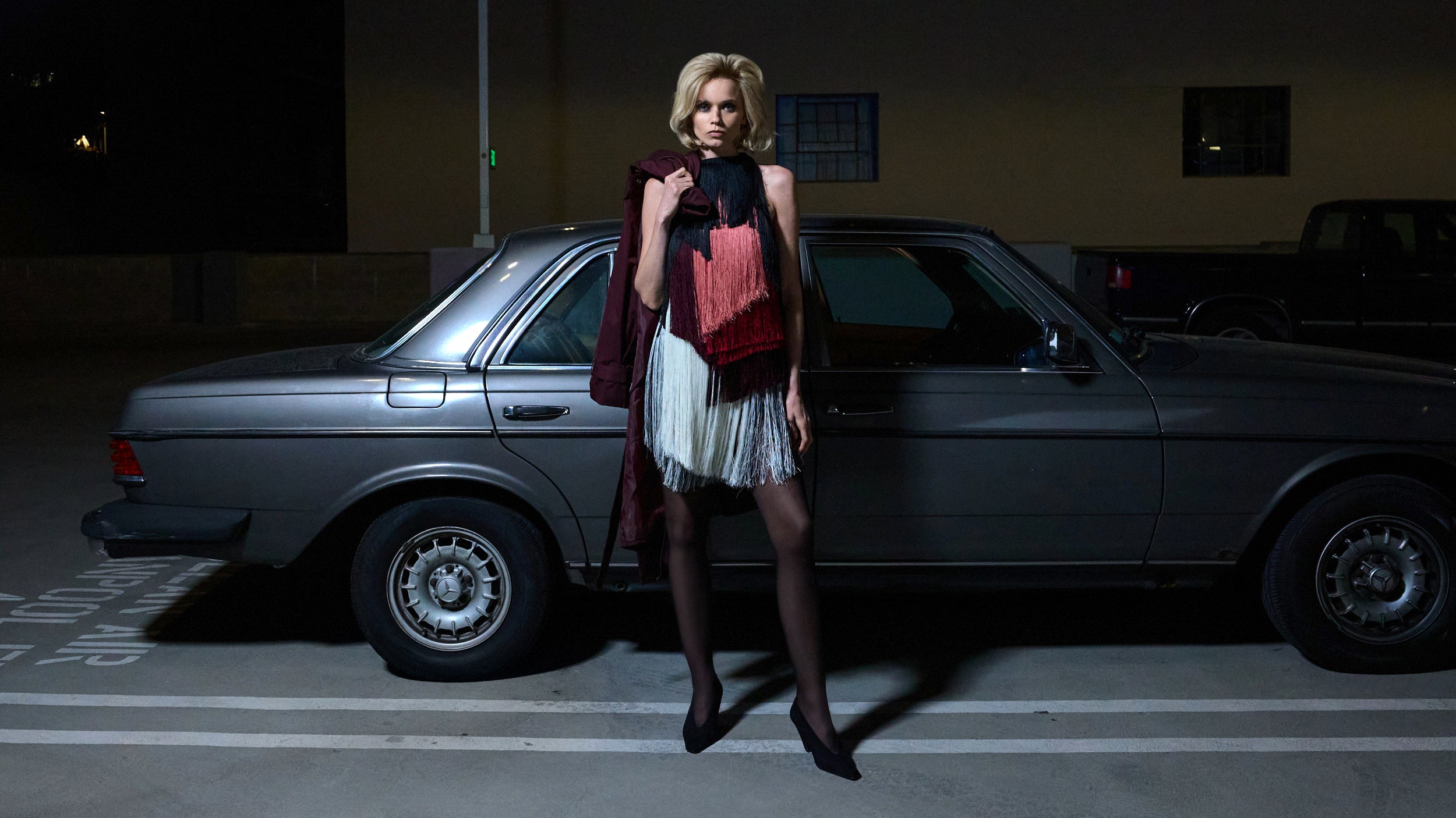 CAMILLA AND MARC PF26 - Evara Fringe Mini Dress in front of car.