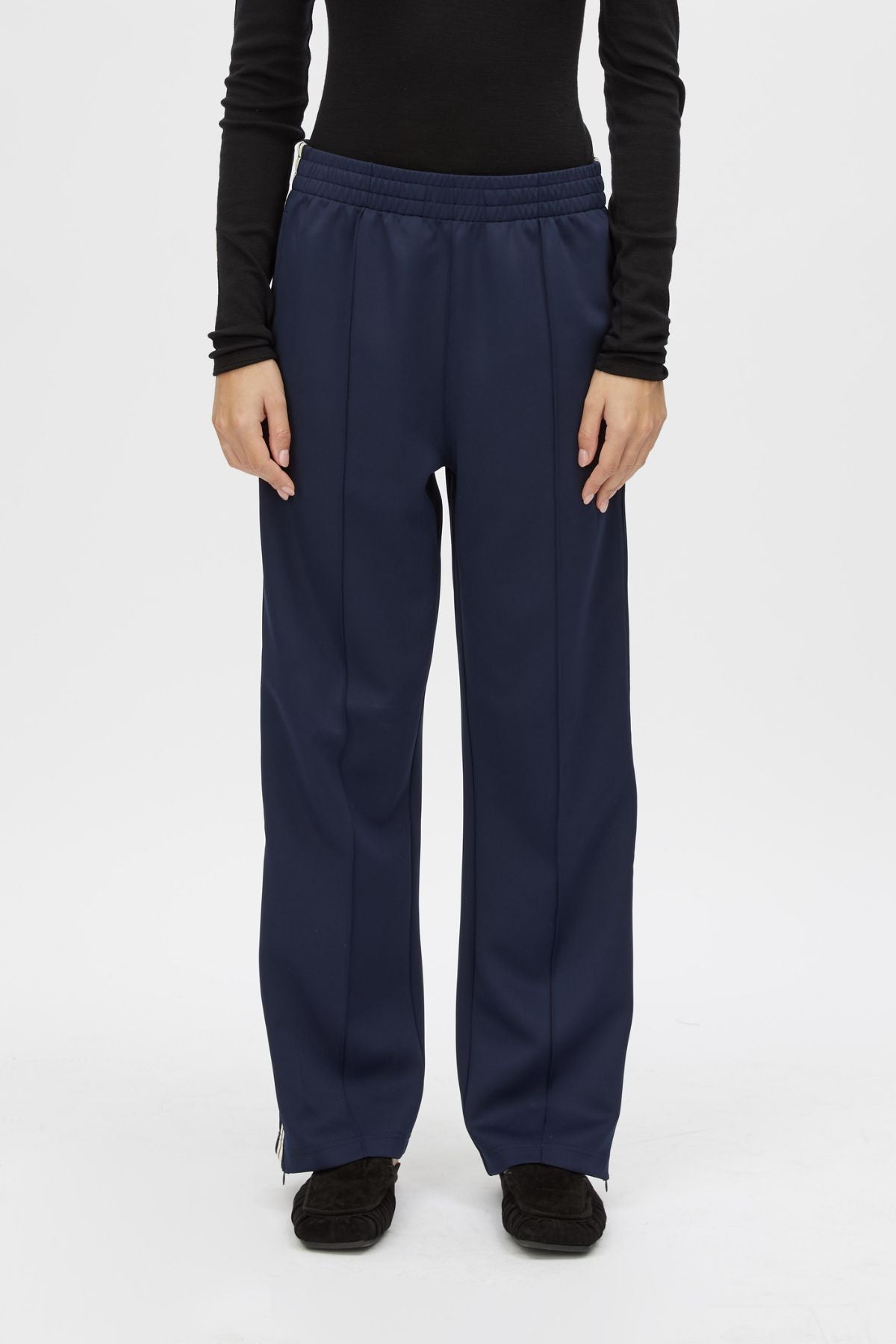 Cropped view CAMILLA AND MARC Locus Scuba Pant in Midnight with a mid‑rise fit and side‑stripe tape.