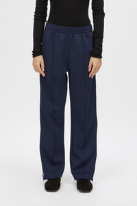Cropped view CAMILLA AND MARC Locus Scuba Pant in Midnight with a mid‑rise fit and side‑stripe tape.