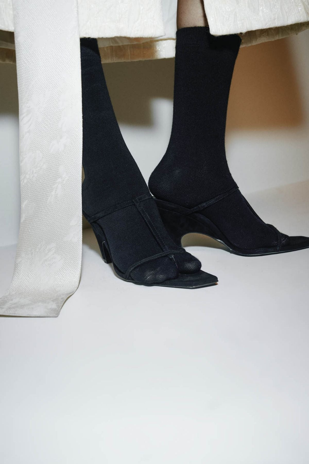 Campaign view CAMILLA AND MARC Wave Mule in black soft goat suede with heeled sandal design.