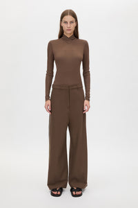 Front view CAMILLA AND MARC Axial Top in Chocolate with layered cross‑over high neck.